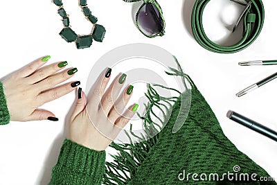 Fashionable green manicure on long nails and stylish accessories Stock Photo