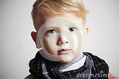 Fashionable handsome little boy in scarf.stylish haircut.fashion Stock Photo