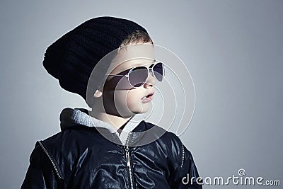 Fashionable little boy in sunglasses. Child in Black cap. Winter style.Kids fashion Stock Photo