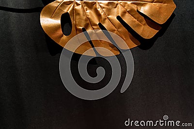 Fashionable luxuary black background with gold monstera leaf. Copy space for text Stock Photo