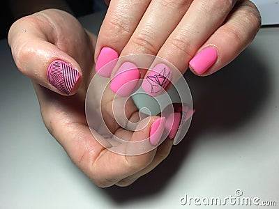 fashionable matte pink manicure with abstraction Stock Photo