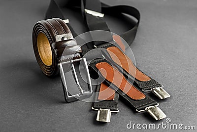 Fashionable men`s brown belt on dark with vintage suspenders Stock Photo