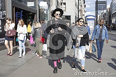 A fashionable men walking through Oxford Street. Editorial Stock Photo