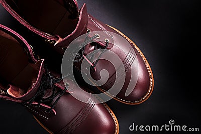 Fashionable mens leather brown shoes on black background. . Men's high boots. Top view. Copy space. Stock Photo
