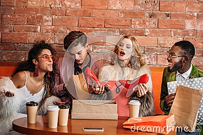 fashionable multiethnic young people looking at trendy red high Stock Photo