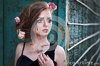 Fashionable portrait of a tearful girl with dry flowers. Retro s Stock Photo