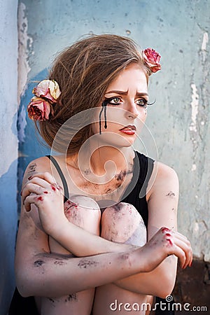 Fashionable portrait of a tearful girl with dry flowers. Retro s Stock Photo