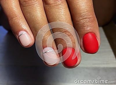 fashionable red matte manicure with shiny silver Stock Photo