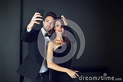 Fashionable rich celebrity couple taking selfie Stock Photo