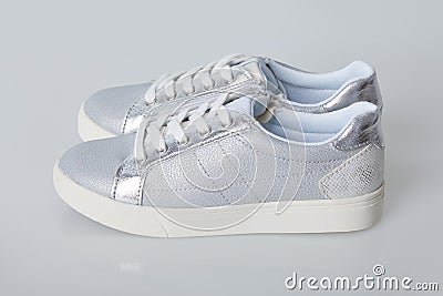 Fashionable silver sneakers for girls Stock Photo