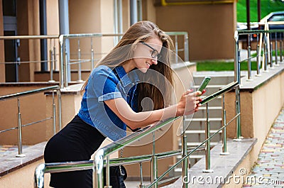 Fashionable slender woman in a denim jacket and a little black d Stock Photo