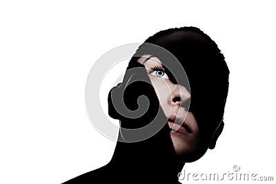 Fashionable studio portrait of a cute girl. Silhouette of a beautiful young woman with hard shadows on her face. against white Stock Photo