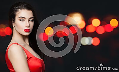 Fashionable woman with red lips makeup on background with abstract night glitter sparkle Stock Photo