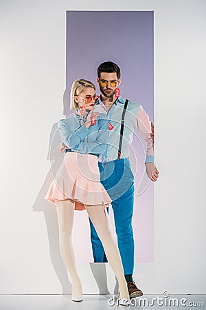 fashionable young couple with sale labels on clothes standing in opening Stock Photo