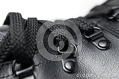 Fashionable youth black leather autumn boots on white background flat lay. Stylish womens mens unisex Grunge boots with bootlace. Stock Photo