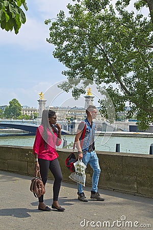 Fashionned tourist walking on the street of Paris Editorial Stock Photo