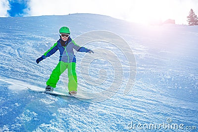 Fast action photo of boy go downhill on snowboard Stock Photo