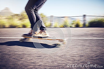 Fast, blur and legs of a man on a skateboard in street for exercise, training and travel in Australia. Fitness, sports Stock Photo