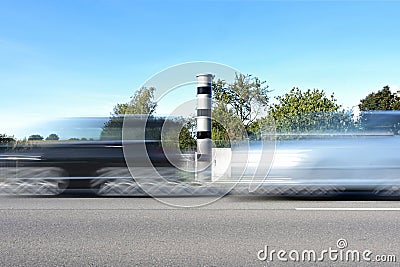 Fast cars in motion blur in front of an automatic speed measurement with light radar and camera for traffic enforcement, speeding Stock Photo