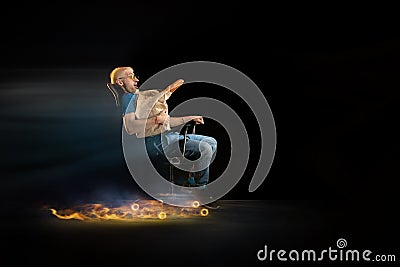 Fast delivery service - deliveryman on chair driving with order in fire on dark background Stock Photo