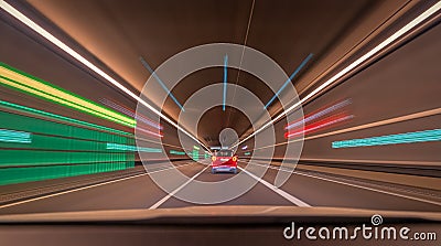 Fast driving car through a tunnel with blurry light effects, a urban race scene with leading lines and symmetry Stock Photo