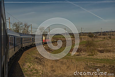 Fast electric train with coaches from Brno to Plzen in spring morning Stock Photo