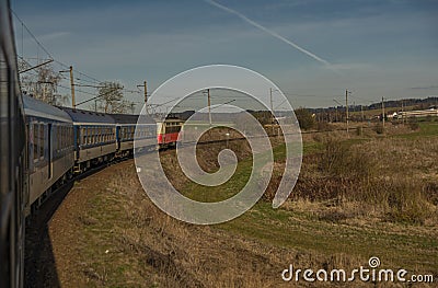Fast electric train with coaches from Brno to Plzen in spring morning Stock Photo
