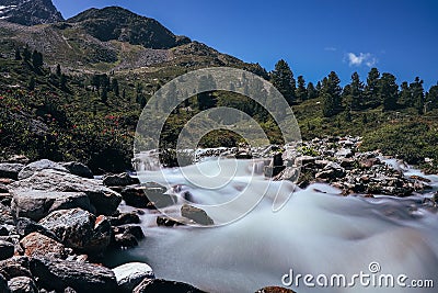 Fast flowing river at the Finstertal dam in the west of Austria. The magical long exposure of water creates a love touch to nature Stock Photo