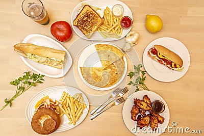 Fast food dishes in a tapas tavern. Alitas de pollo bbq, perrito caliente, sandwich mixto, bocadillo de pollo, hamburguesa clasica Stock Photo