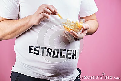 Fast food, hormonal imbalance, overweight man Stock Photo