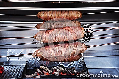 Fast food. Kokorech is cooked on skewers on burning coals. Stock Photo