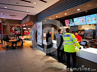 Fast food restaurant indoor - people wait in turn Editorial Stock Photo