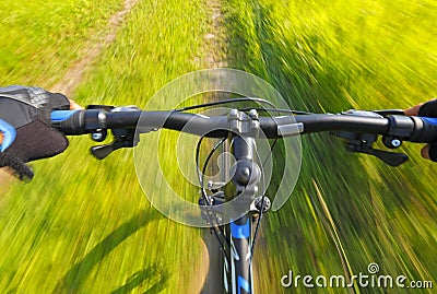 Fast motion mountain bike on a grassy road Stock Photo