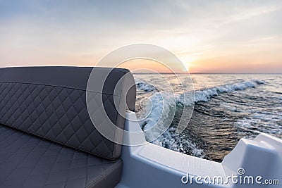 Fast motorboat ride on sea at sunset Stock Photo