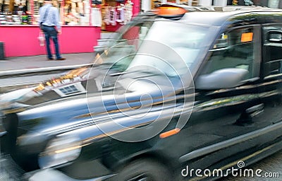 Fast moving blurred taxi in London Stock Photo