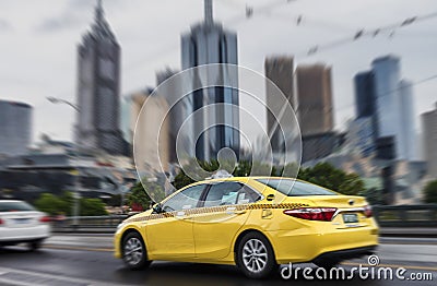 Fast moving taxi in Downtown Melbourne, Australia Stock Photo