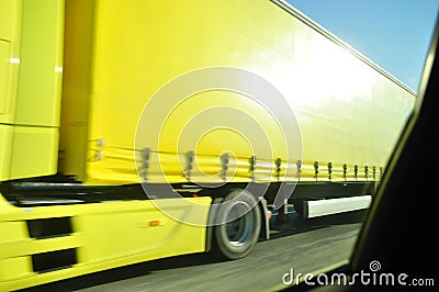 Fast moving yellow truck Stock Photo