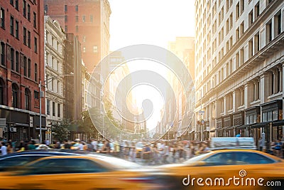 Fast-paced life in New York City street scene with cabs driving down 5th Avenue and crowds of people in New York City Stock Photo