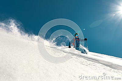 Fast skier rides over ski slope Stock Photo