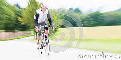 Fast Sport Bicyclist on bike with motion blur Stock Photo