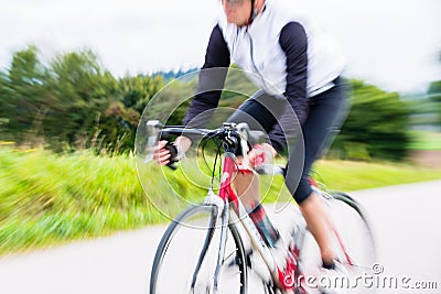 Fast Sport Bicyclist on bike with motion blur Stock Photo