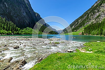 Fast water stream flow into mountain lake. Summer mountain landscape in the Alps, Austria, Tyrol Stock Photo