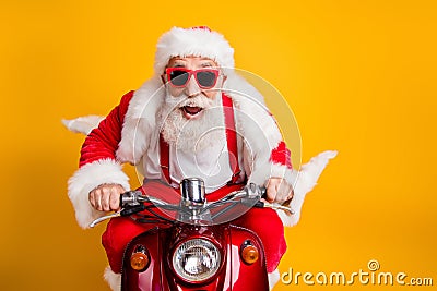 Fast x-mas traveling. Crazy funky hipster grey haired santa claus in red hat drive scooter hurry scream wear shirt Stock Photo