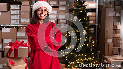 Fast xmas delivery concept. Portrait of Happy funny Santa Claus with present gift box looking at camera standing in Stock Photo
