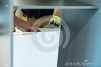 Fastening of plywood to a case, a back wall of a case, installation of a sliding wardrobe. Stock Photo