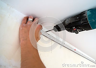 Fastening to the wall guide for stretch ceiling Stock Photo