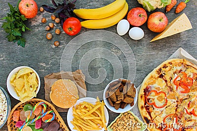 Fastfood and healthy food on old wooden background. Stock Photo