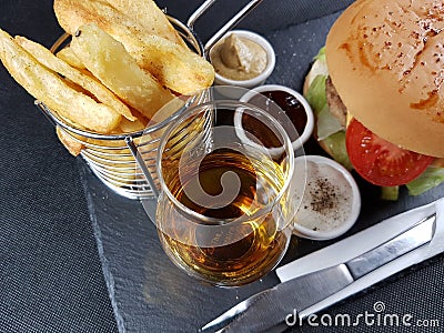 Fastfood lunch dinner eat drink blackplate blackbackground singlemalt Stock Photo