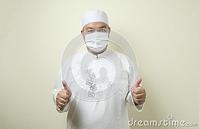 Fat Asian muslim men wearing masks with confident gestures Stock Photo