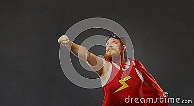 Fat funny man in a superhero costume. Stock Photo